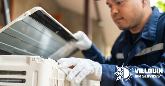 Technician inspecting HVAC outdoors