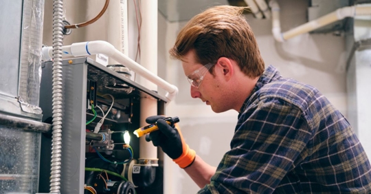 Technician inspecting a furnace